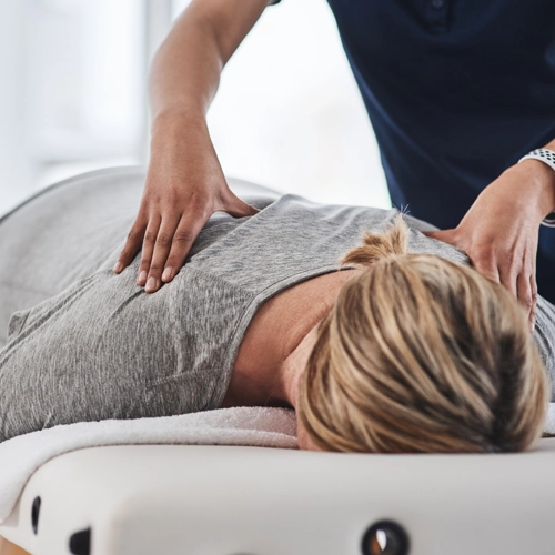 Pain Relief Elkton MD Woman Receiving Chiropractic Care